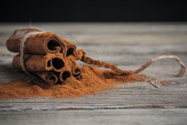 Cinnamon sticks on wooden background