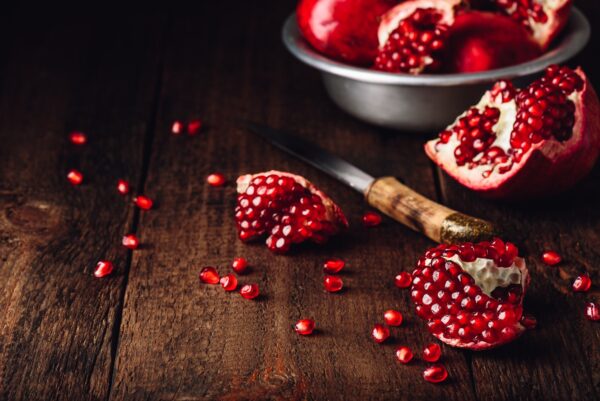 Pomegranate fruits with knife